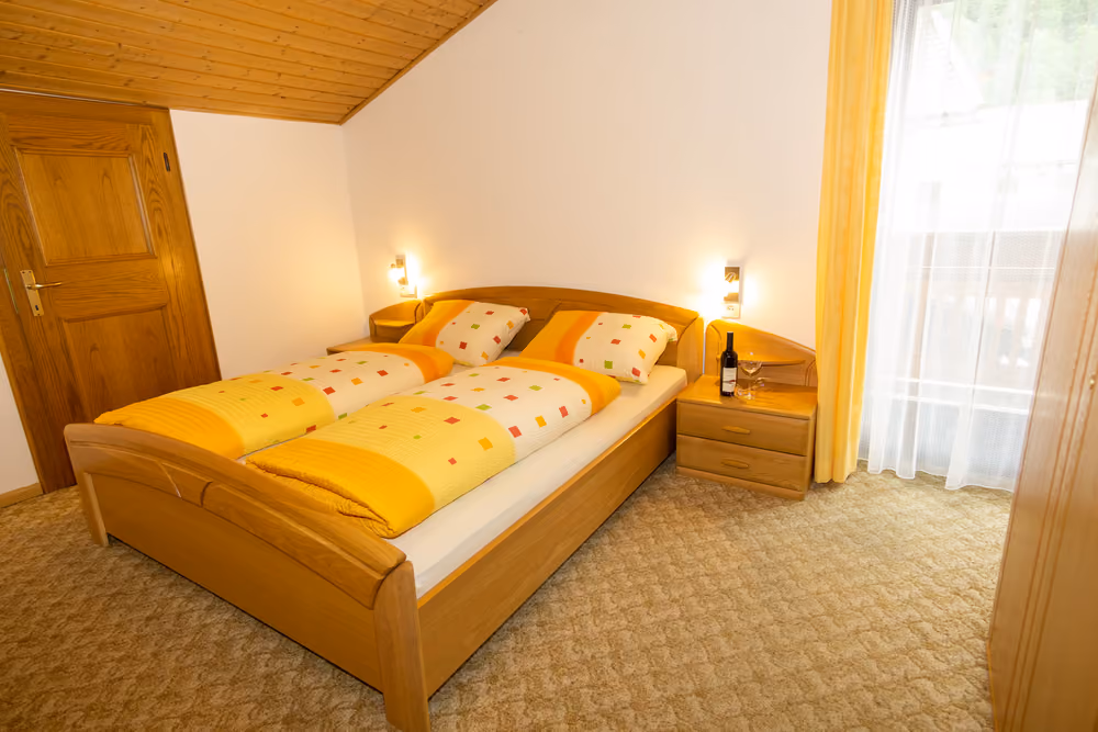 Schlafzimmer mit Doppelbett und Balkontür
